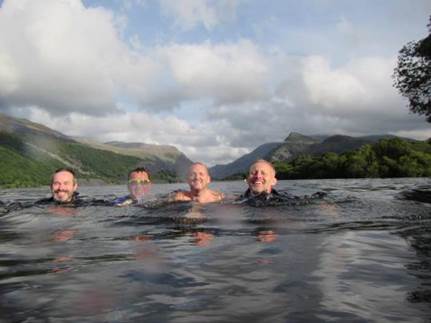 Image may contain: 4 people, people smiling, swimming, outdoor, nature and water